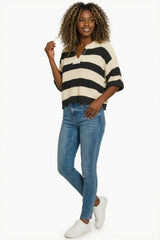 Model wearing a Zenana Split Neck Stripe Sweater with black and cream stripes paired with blue jeans.